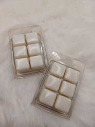 Vanilla-scented wax melts in a clear plastic container with a grid of six square compartments.