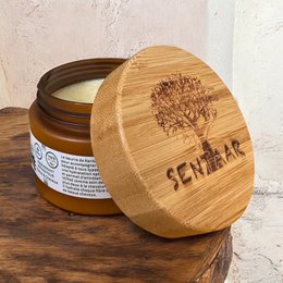 Raw shea butter in amber glass jar with natural bamboo lid, unrefined organic skincare product