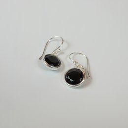 Elegant silver hoop earrings with round black stones, perfect for casual or formal wear.