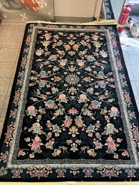 Large dark blue area rug with intricate floral and geometric patterns, suitable for living rooms or bedrooms.