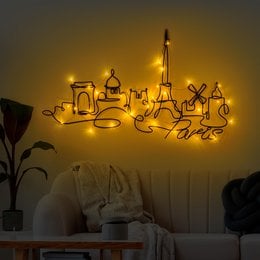 Metal wall light with LED bulbs in a modern, industrial design. Features a rectangular shape with a black finish and warm yellow lighting.