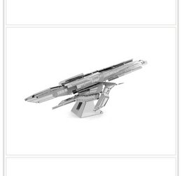 Metal construction kit of a Star Wars Turan Cruiser spacecraft. The kit features a detailed, angular design with various components and details.