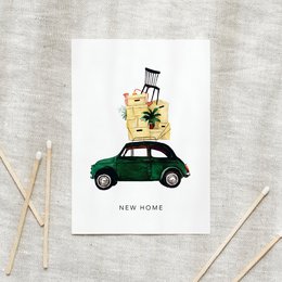 A green vintage car with a suitcase on top, against a white background with the text "New Home" on the postcard.