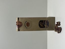 Unsalted pecan nuts in a brown paper bag. The nuts are whole and appear to be of high quality.