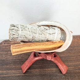 Incense set with sage, Palo Santo, and abalone shell for spiritual cleansing. Includes natural materials like wood and stone.
