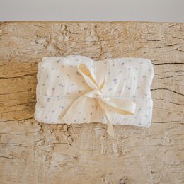 Soft, plush changing mat with white and gray polka dot pattern. Provides a comfortable surface for baby during diaper changes.