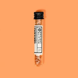  Butterscotch-colored face makeup with a shimmery, glittery texture.