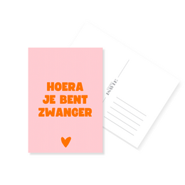 Pink congratulations card with orange text "Hoera je bent zwanger" and red heart shape, pregnancy announcement greeting card.
