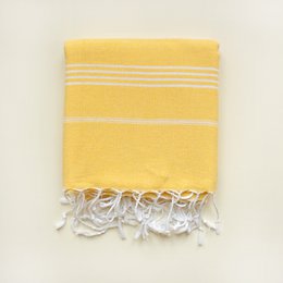 Yellow striped beach towel with tassels