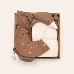 Brown and cream baby gift set with soft plush toy, blanket, and decorative packaging.