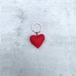 A red heart-shaped keyring with a metal ring.