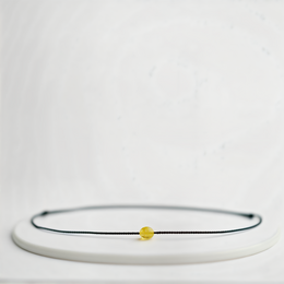 A delicate golden bead bracelet with a simple, minimalist design.