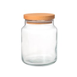 A clear glass storage jar with a wooden lid, measuring 7 cm in diameter and 9 cm in height. This versatile jar can be used to store a variety of items such as coffee, spices, or candy.