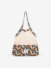 Cream-colored handbag with a floral print pattern and adjustable straps.