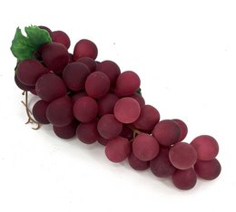 Dark red round grapes bunch artificial fruit decoration with green leaves