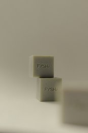 Grapefruit and Dead Sea mud soap bars, rectangular shape, light green color, with "FYSH" text printed on the surface.