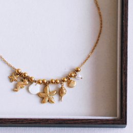 Beaded necklace with ‘Salt & Sea’ charms