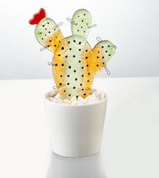 Decorative cactus statue in yellow, green, and red colors with polka dot patterns.
