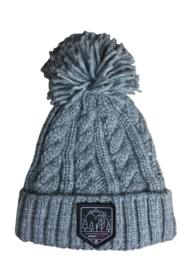 Grey cable knit beanie with pom pom. Made of warm, soft material. Features a logo patch on the front.