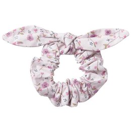  A white scrunchie with a pink floral pattern. The scrunchie has a bow detail on top.