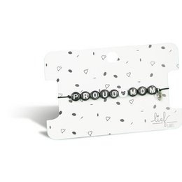 A black and white bracelet with the text "Proud Mom" displayed on a card.