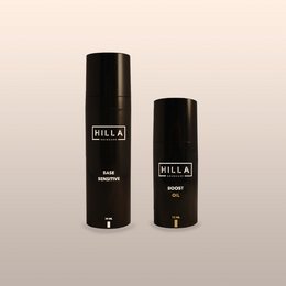 Two black bottles of day cream for sensitive skin and oil boost. The cream is designed to hydrate and nourish sensitive skin while providing an oil boost for a healthy, radiant complexion.
