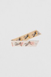 Beige scarf with printed rabbits, woven bracelet material.