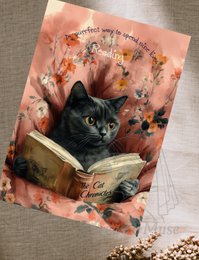  A black cat reading a book, surrounded by autumn leaves and flowers.