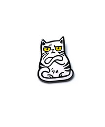 Decorative cat-shaped brooch with a stylized design and yellow accents.