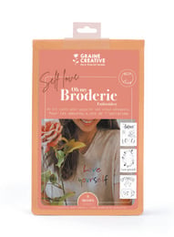 Embroidery kit for a women's t-shirt with a "Self Love" design. The kit includes an embroidery hoop, embroidery floss, and a pre-printed fabric panel.