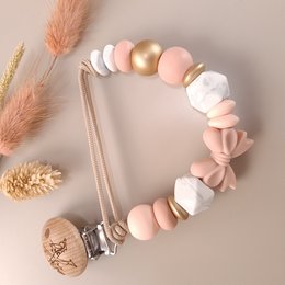 Pacifier clip with golden rose, pink and white beads, and a metal clip. Suitable for babies and toddlers.