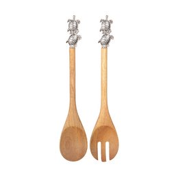 Wooden salad servers with silver turtle-shaped handles. The servers have a natural, rustic appearance and are suitable for serving salads or other dishes.