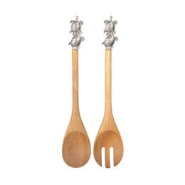 Wooden salad servers with silver turtle-shaped handles. The servers have a natural, rustic appearance and are suitable for serving salads or other dishes.