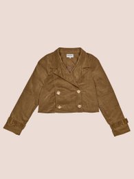 Khaki velvet jacket with double-breasted closure, long sleeves, and a collar. Paired with a long, textured white skirt.
