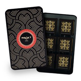 Dark chocolate squares in a metal pencil case. The case features a repeating spider web pattern in black and orange. Each square is individually wrapped in gold foil.
