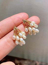 Gold-tone stud earrings with white pearl cluster drops, elegant chandelier style, delicate gemstone embellishment