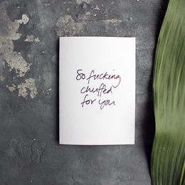 A hand-foiled greetings card with the text "So fucking chuffed for you" written in cursive.