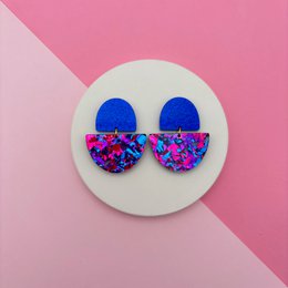 Colorful drop earrings with blue and multicolored geometric pattern, vibrant statement jewelry piece.