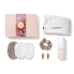  A gift set containing various beauty products, including a plush white robe, presented in a pink gift box.