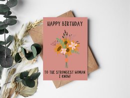 "A birthday card with a floral bouquet and the text 'Happy Birthday to the strongest woman I know'."
The birthday card features a vibrant floral bouquet in shades of pink, yellow, and white against a pink background. The text on the card reads "Happy Birthday to the strongest woman I know." This personalized card is suitable for celebrating a strong, resilient woman on her birthday.