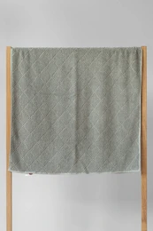 Moss green terry cotton bath towel with a soft, plush texture.