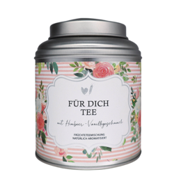 Floral tin canister with "For Dich Tea" label, containing loose leaf tea. Tin has a silver lid and colorful floral design.