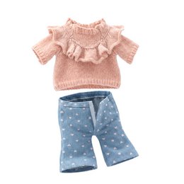 A pink hooded plush jumpsuit with a belt, perfect for a mountain stroll. The outfit includes a matching hat.