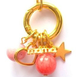 Gold-tone necklace with pink heart and star charms, featuring the word "mama" in a stylized font.