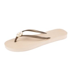 Beige slip-on sandals with floral embellishments. Casual, comfortable footwear suitable for everyday wear.