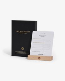 Productivity planner display cards with a wooden stand, featuring a black cover and a checklist-style layout.