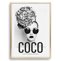 Black and white poster featuring a stylized portrait of Coco Chanel wearing sunglasses, with the text "COCO" prominently displayed.