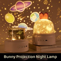  Bunny-shaped galaxy projection night lamp with rotating planets, stars, multiple lighting modes, pink and blue variants for kids' rooms.