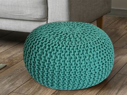 Round, knitted pouf in dark gray color. Soft, comfortable floor cushion or ottoman made of sustainable materials.