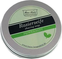 Peppermint-scented vegan shaving soap in a round tin container. The soap is white in color and has the brand name "Hans Baier" embossed on the surface.